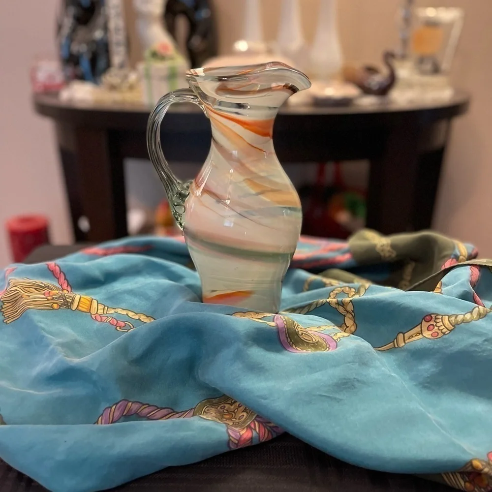 Vintage hand blown art glass swirl pitcher with applied handle.